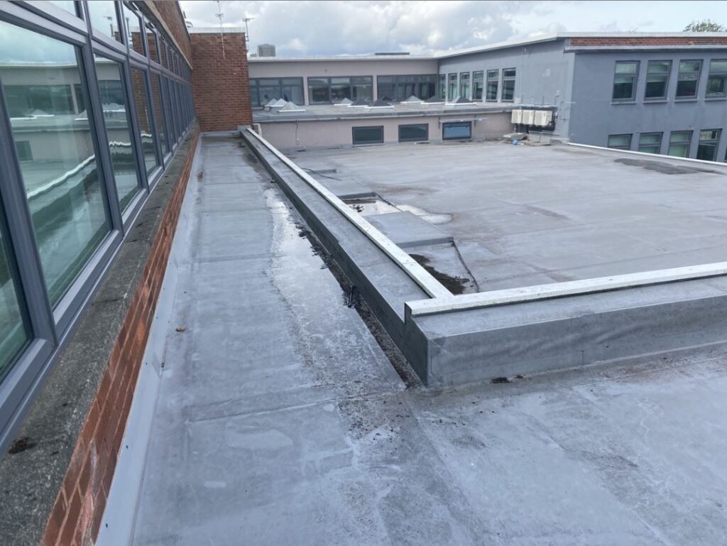 Photo of the Dixons Croxteth Academy roof before the IKO system installation