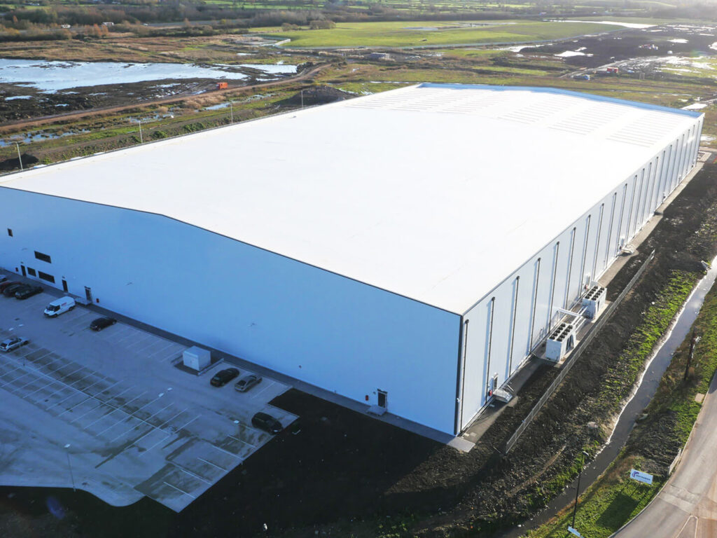 Photo of a completed IKO Spectraplan mechanically fixed roofing system on a warehouse roof