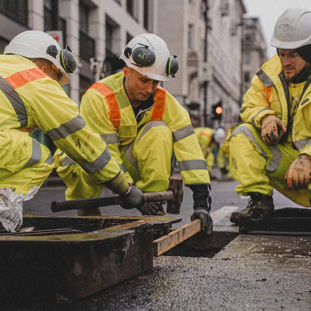 A photo of mastic asphalt contractors installing the IKO Pacopatch ironworks reinstatement system into a road surface in Piccadilly, London