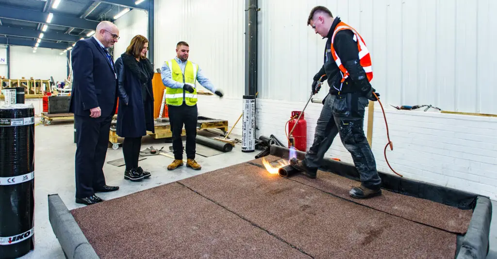 Photo of a SIMIAN Apprentice installing IKO PLC torch-on felt