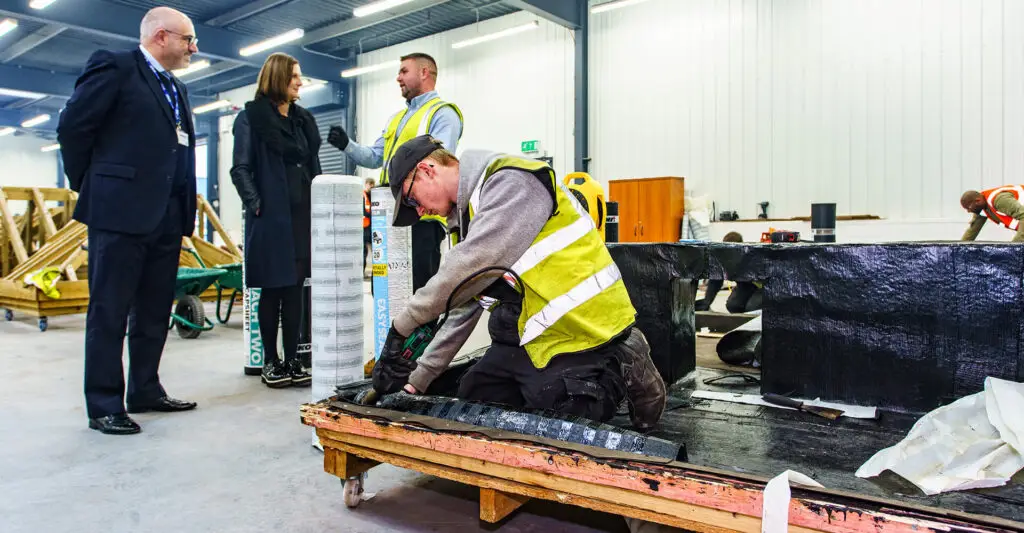 Photo of a SIMIAN Apprentice installing IKO PLC self-adhesive felt