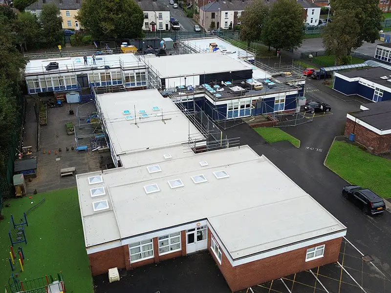 Aerial photograph of an IKO metatech cold applied liquid system being installed at Mossfield Primary School in Manchester