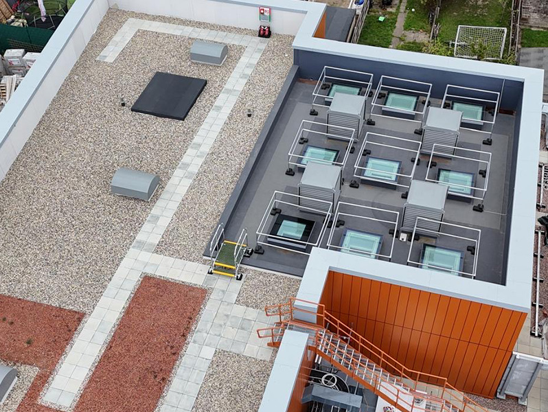 Photo of the IKO Permatec LI hot melt inverted roofing system, IKO Armourplan PSG single ply roofing system, and IKO Elements Extensive Green Roof at the Oxlow Bridge SEND School project