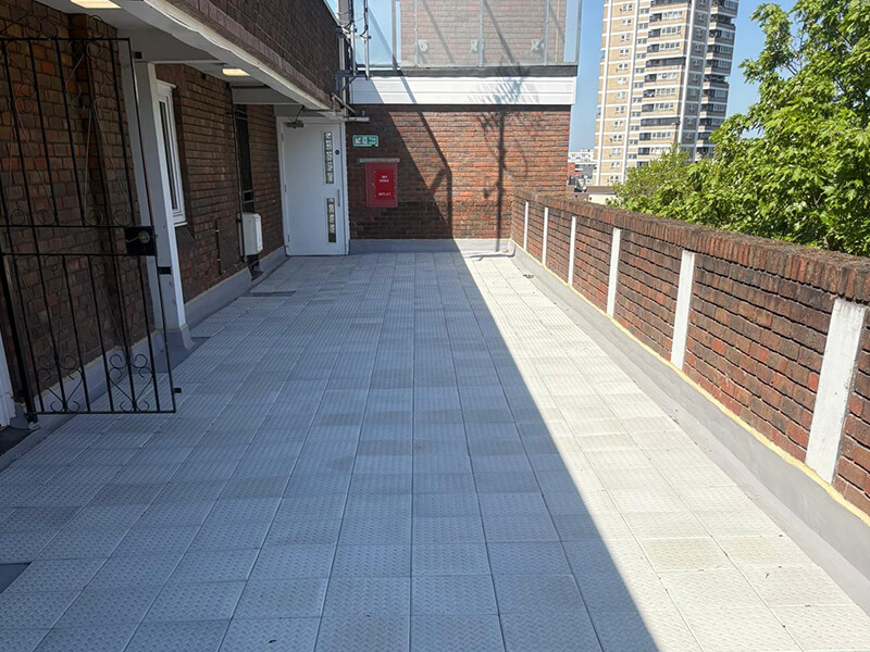 Balcony deck waterproofing project at Couzens House featuring IKO Permaphalt and checker plate tile finish