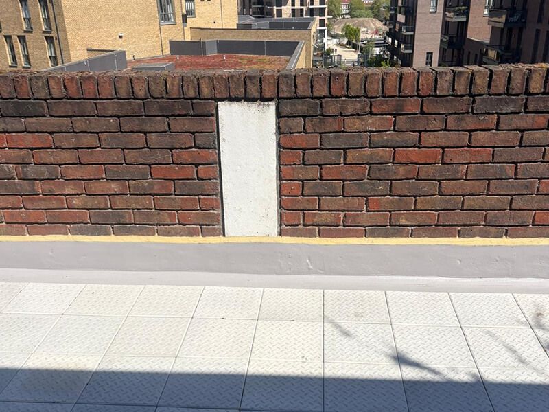 Balcony deck edge detail showing completed waterproofing system at Couzens House, London
